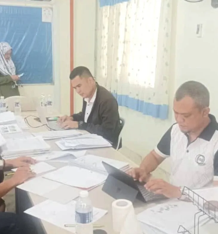 Auditor and assessor reviewing documents