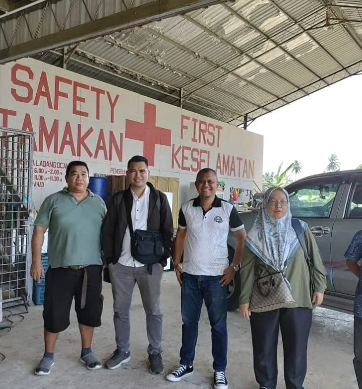 Audit team standing in front of the estate first aid and safety station in Lahad Datu